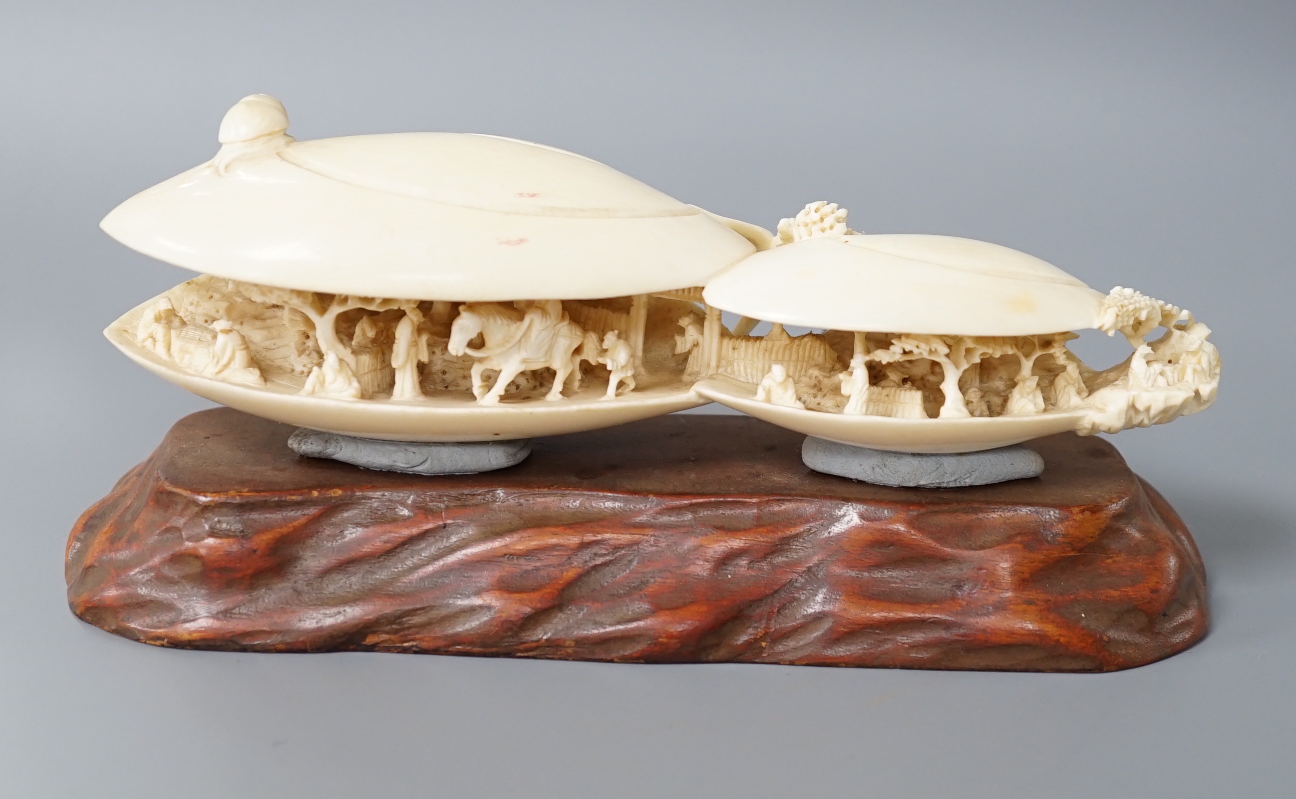 A large Japanese ivory model of the clam’s dream, Meiji period, wood stand. 18cm long